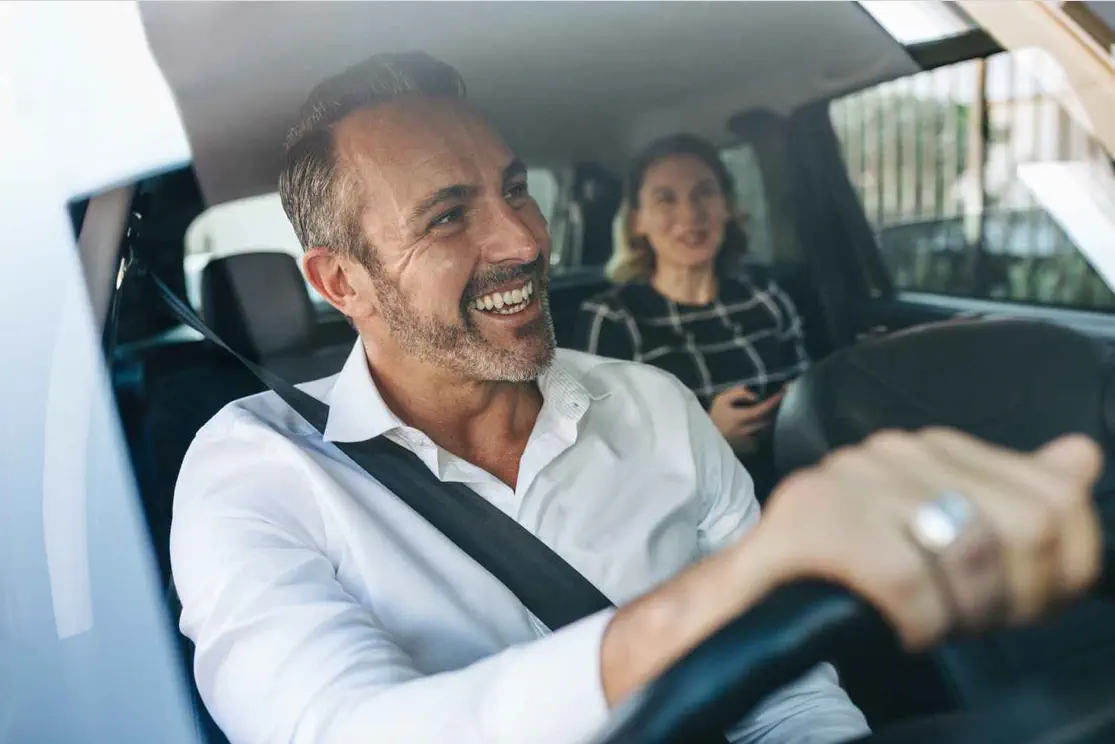 Happy family driving in car.