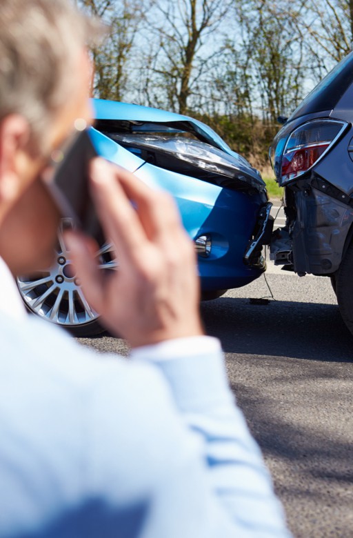 Man on phone after car accident